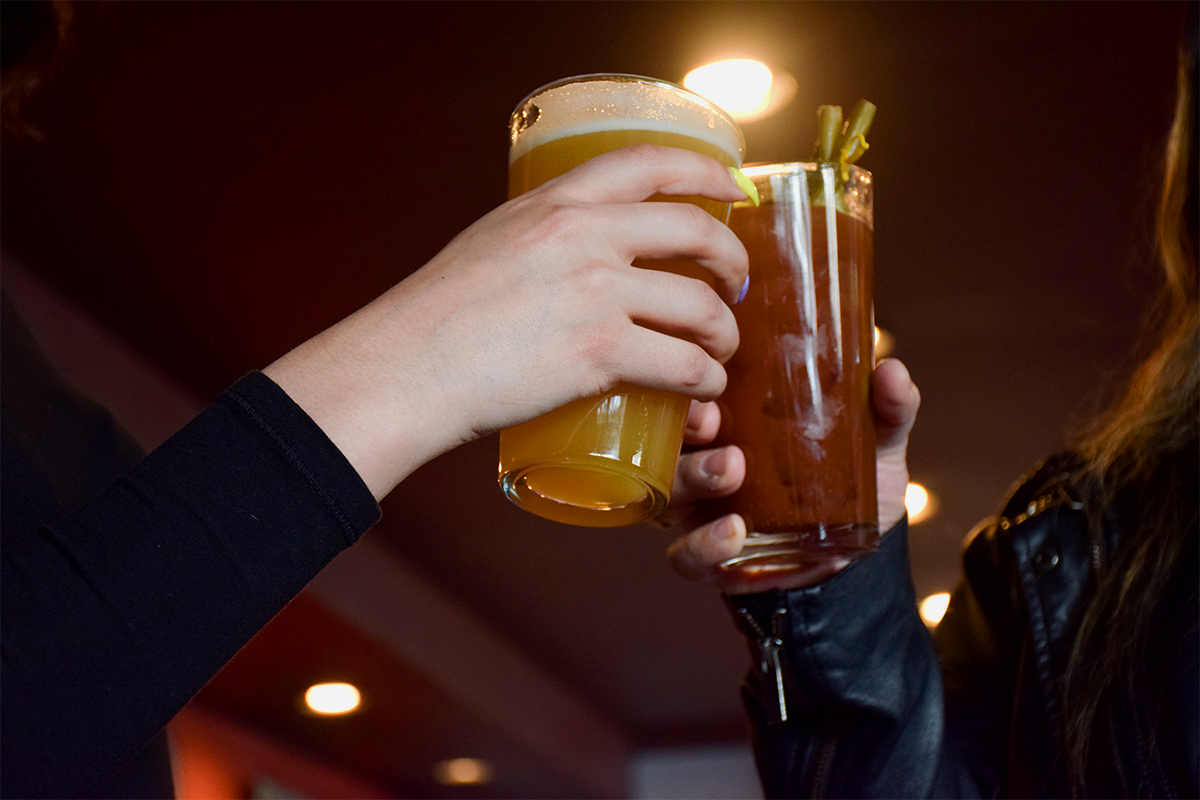 People clinking their drinks together.