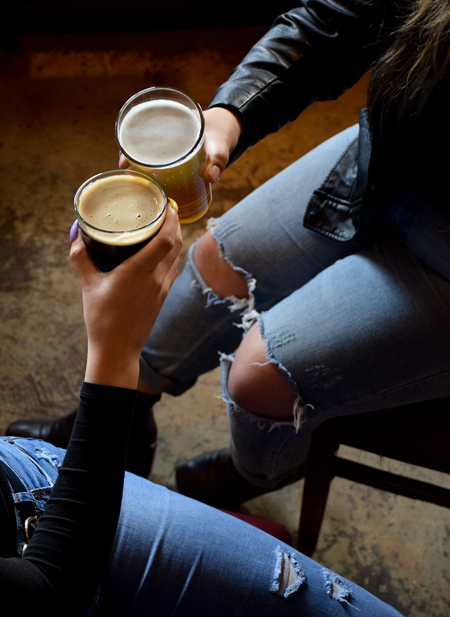People clinking beers together.