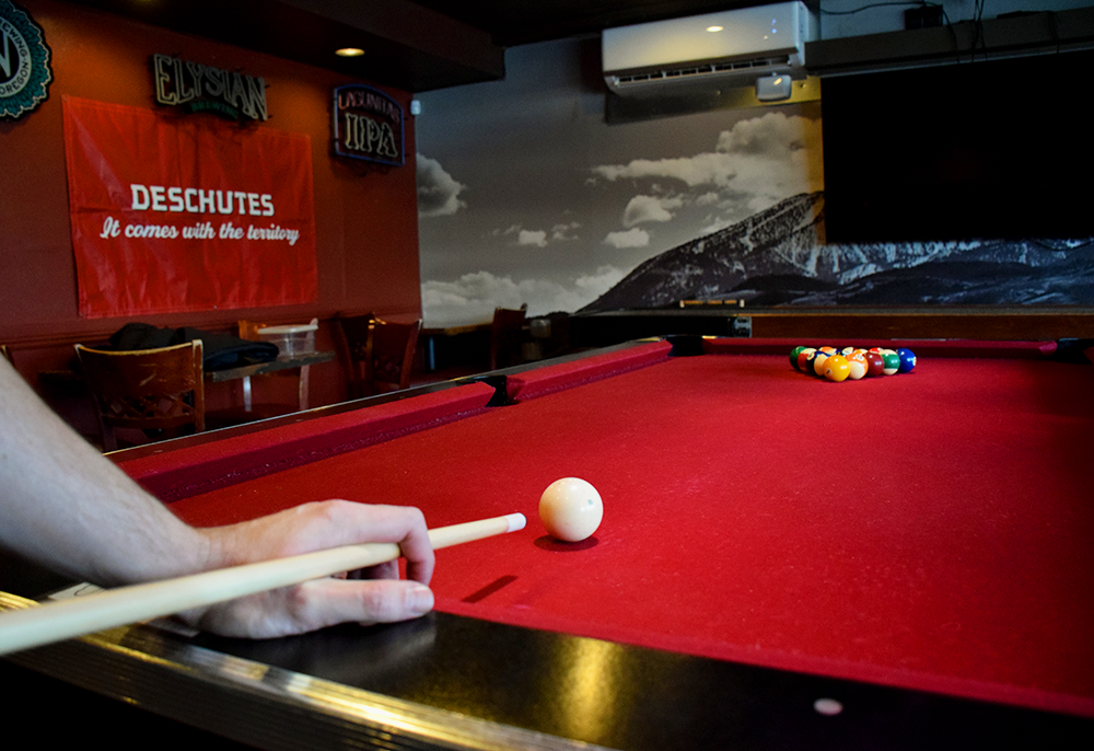 Person playing pool.